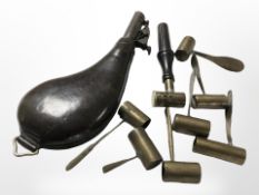 A 19th-century embossed leather shot flask and a group of powder measures.