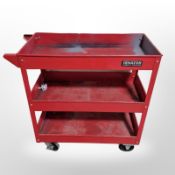 An enamelled metal three tier work shop trolley,