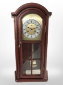 A reproduction Hermle wall clock, length 67cm.