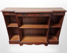 A reproduction inlaid mahogany breakfront bookcase,