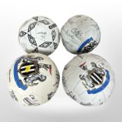 Three Newcastle United footballs, plus another, all with team signatures.
