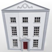A Georgian style three storey doll's house containing a good collection of doll's house furniture,