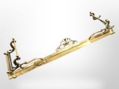 A late-Victorian brass extending fire curb.