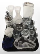 A group of glass wares including cocktail shaker, large paperweight depicting seals,