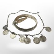 An engraved silver bangle and a three pence coin necklace.