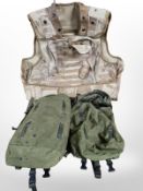 A desert pattern body armour vest and two military canvas bags
