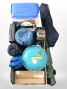 A collection of camping equipment including folding chairs, cooler, barbecue, sleeping bags, etc.