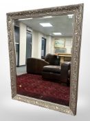 A reproduction bevelled mirror in an ornate frame,