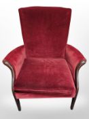A Parker Knoll armchair in Burgundy dralon,