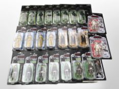 24 Kenner Star Wars figurines including The Last Jedi, Solo, The Mandalorian, etc., boxed.