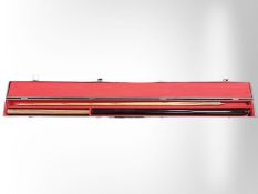 A two-piece snooker cue with extension in carry case
