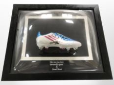 A framed football boot signed by Lionel Messi with certificate of authenticity,
