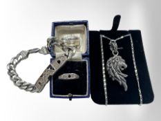 A silver 'Dad' bracelet, a further silver lion pendant on chain, and a three-stone dress ring.