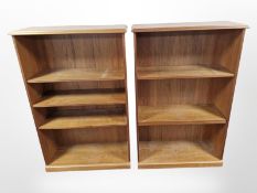 A pair of teak open bookcases,