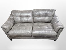 A contemporary charcoal grey stitched leather three seater settee,