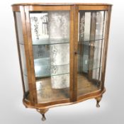 A 1950's walnut serpentine front china cabinet,
