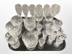 A group of drinking glasses including five toasting glasses etched with thistles, tumblers,