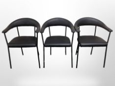 A set of three contemporary metal-framed black vinyl armchairs.