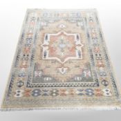 A Caucasian design wool rug on beige ground,
