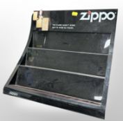 A Zippo lighter plastic display stand, width 39cm.
