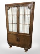 A 1930's carved oak double door cabinet,