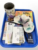 A tin of vintage glass marbles, stamps and first day covers, police epaulets, I-Spy books,