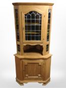 A Danish blonde oak leaded glass corner cabinet, height 180cm.