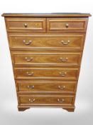 A Stag seven drawer chest with plate glass top,