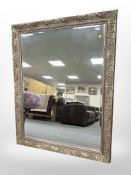 A reproduction bevelled mirror in an ornate frame,