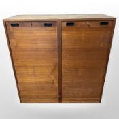 A 20th century Danish teak tambour front office storage cabinet with shelved interior,