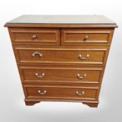 A Stag five drawer chest with plate glass top,