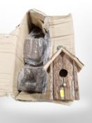 A box of rustic wooden bird houses