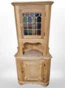 A Danish blond oak and stained glass corner corner,