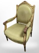 A 20th century French gilt wood armchair in striped upholstery,