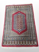 An Iranian fringed rug on red ground,