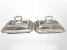 A pair of silver-plated lidded muffin dishes, width 27cm.