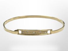 A yellow gold bangle set with diamonds, approx 6cm diameter, 9.6g.