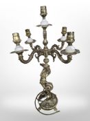 An ornate brass five sconce table lamp with central mermaid support,