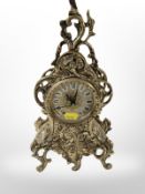 A reproduction cast-brass Rococo-style quartz mantel timepiece, height 33cm.