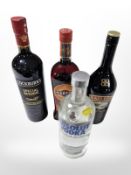 Four bottles of alcohol to include Martini, Baileys, Cockburns port, and Absolut vodka.