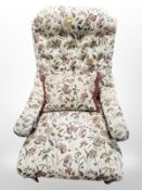 A late Victorian mahogany library armchair in floral fabric