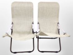 A pair of adjustable garden armchairs with plastic mesh seats.