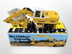 A Liebherr die-cast scale metal excavator, in box.