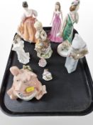 A Wade Natwest pig, together with four Royal Doulton figures of ladies,