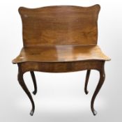 A 19th century mahogany serpentine front tea table,