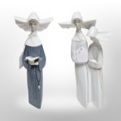Two Lladró figures of nuns.