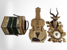 A contemporary Black Forest-style barometer, an accordion,