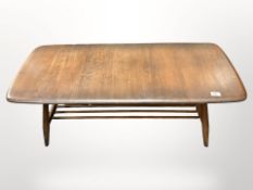 An Ercol stained elm coffee table with under shelf,