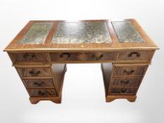 A reproduction yew wood eight drawer twin pedestal desk,