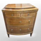 An early-20th century continental Biedermeier-style bow-front mahogany four-drawer chest,